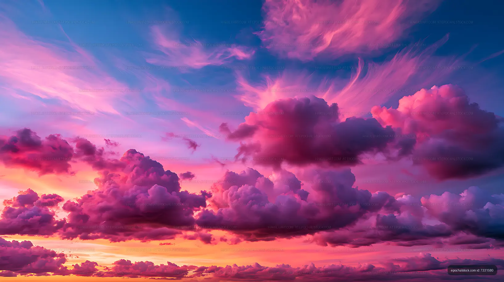 Vibrant pink cloudscape over a glowing sunset horizon