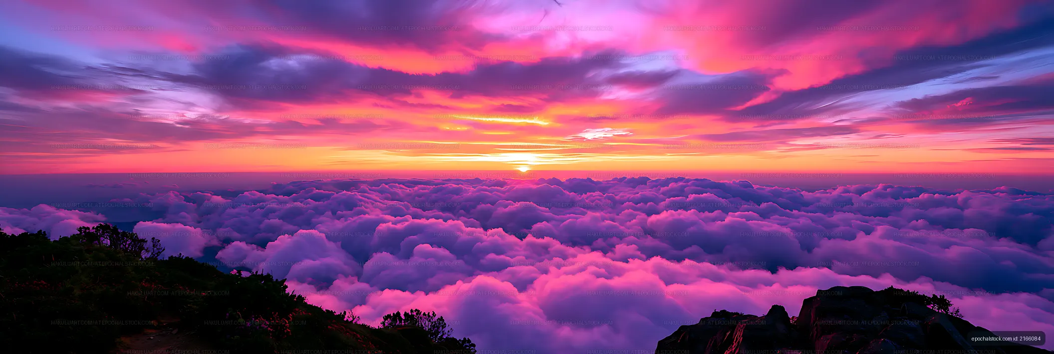 Panoramic pink and purple sunset over a cloud layer