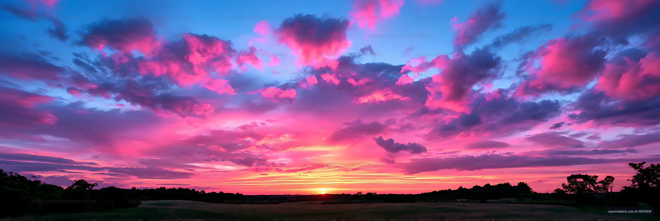 Pink and purple clouds above a rural sunset horizon