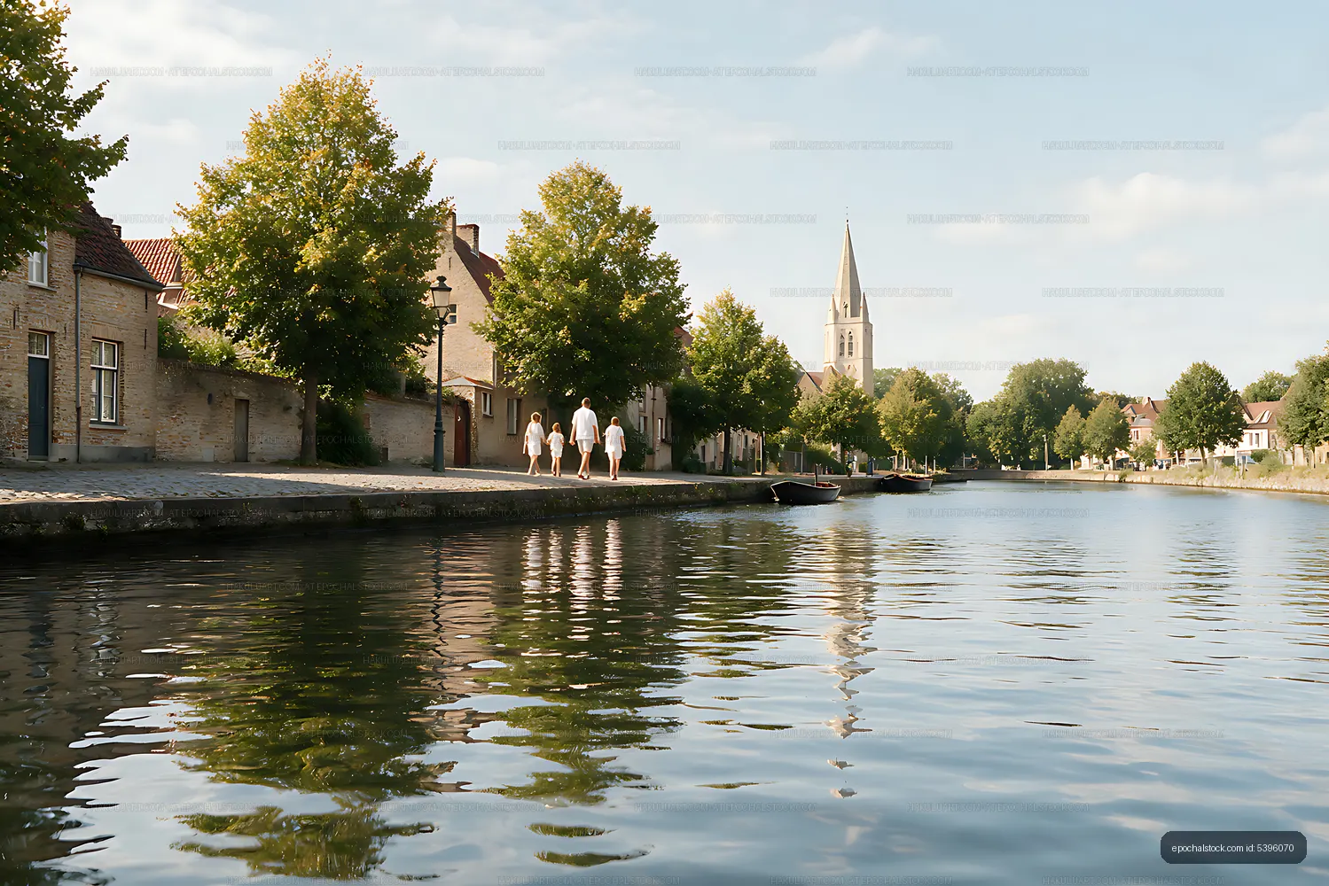 Family walking beside village canal with church steeple