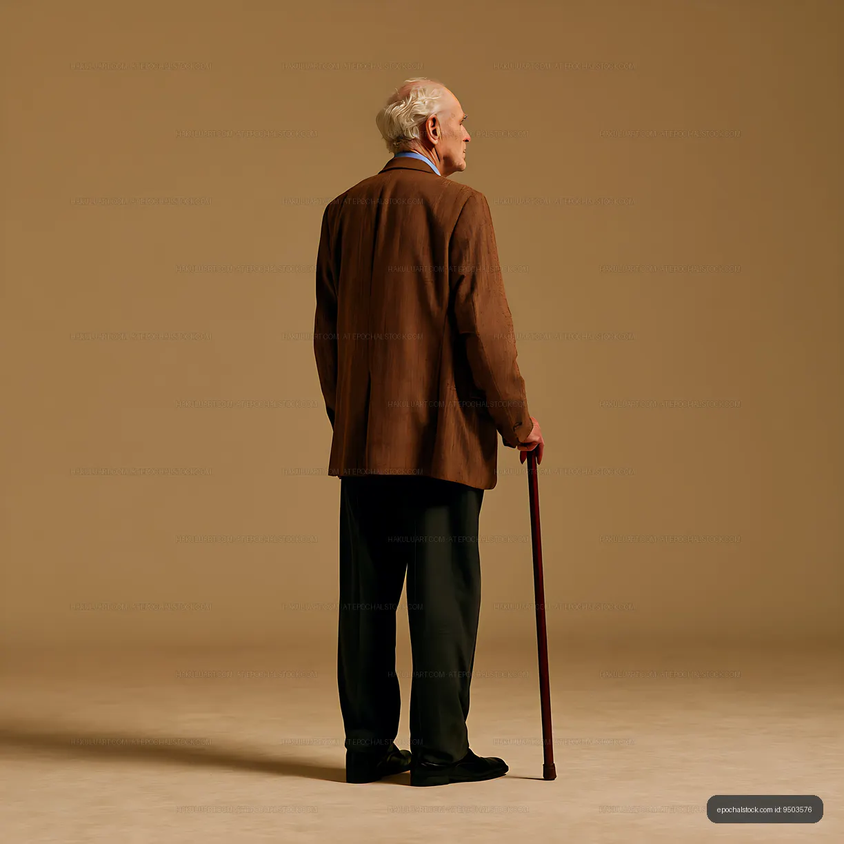 Senior man with cane in minimalist warm-toned studio portrait