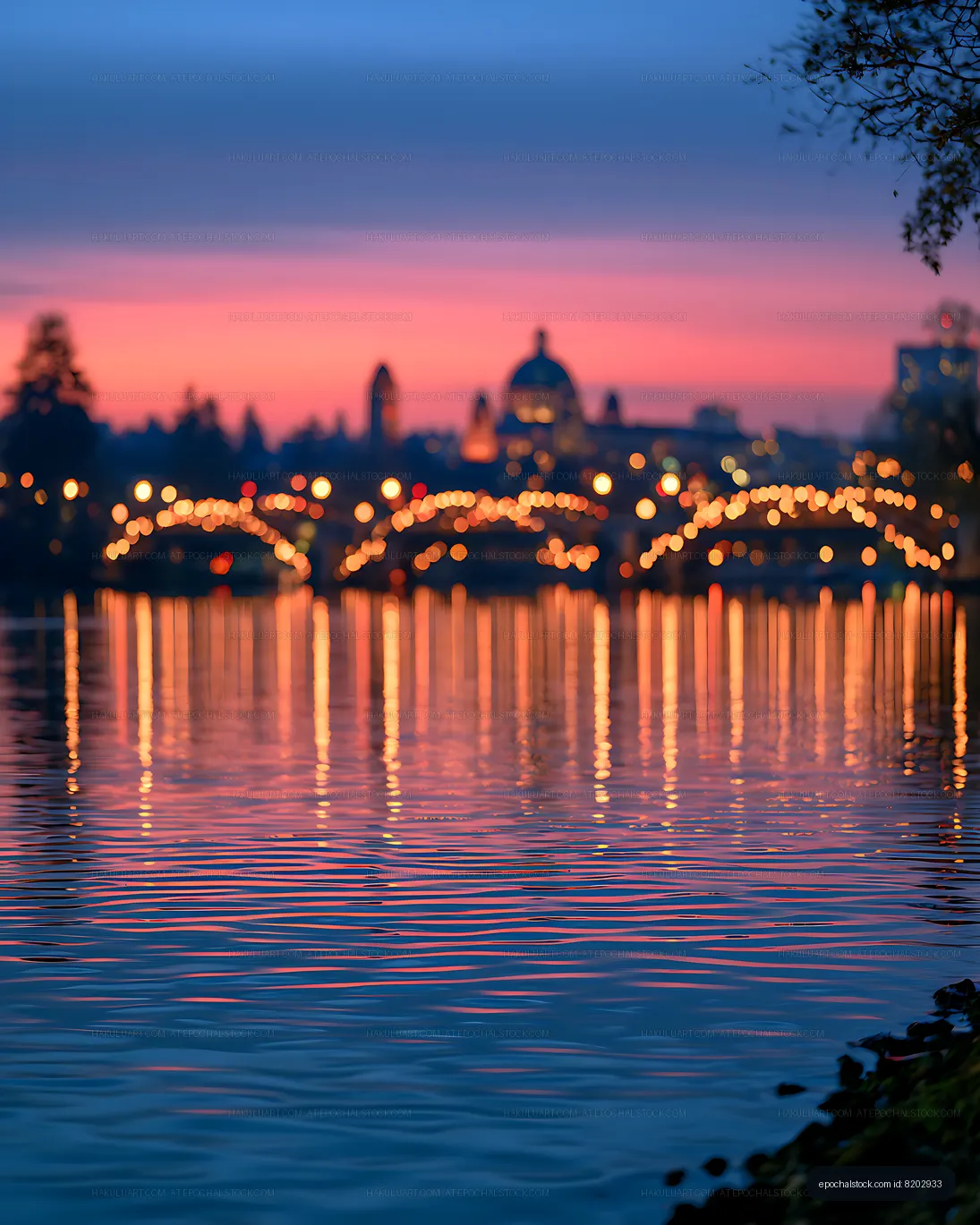 Soft focus city skyline over reflective water at dusk