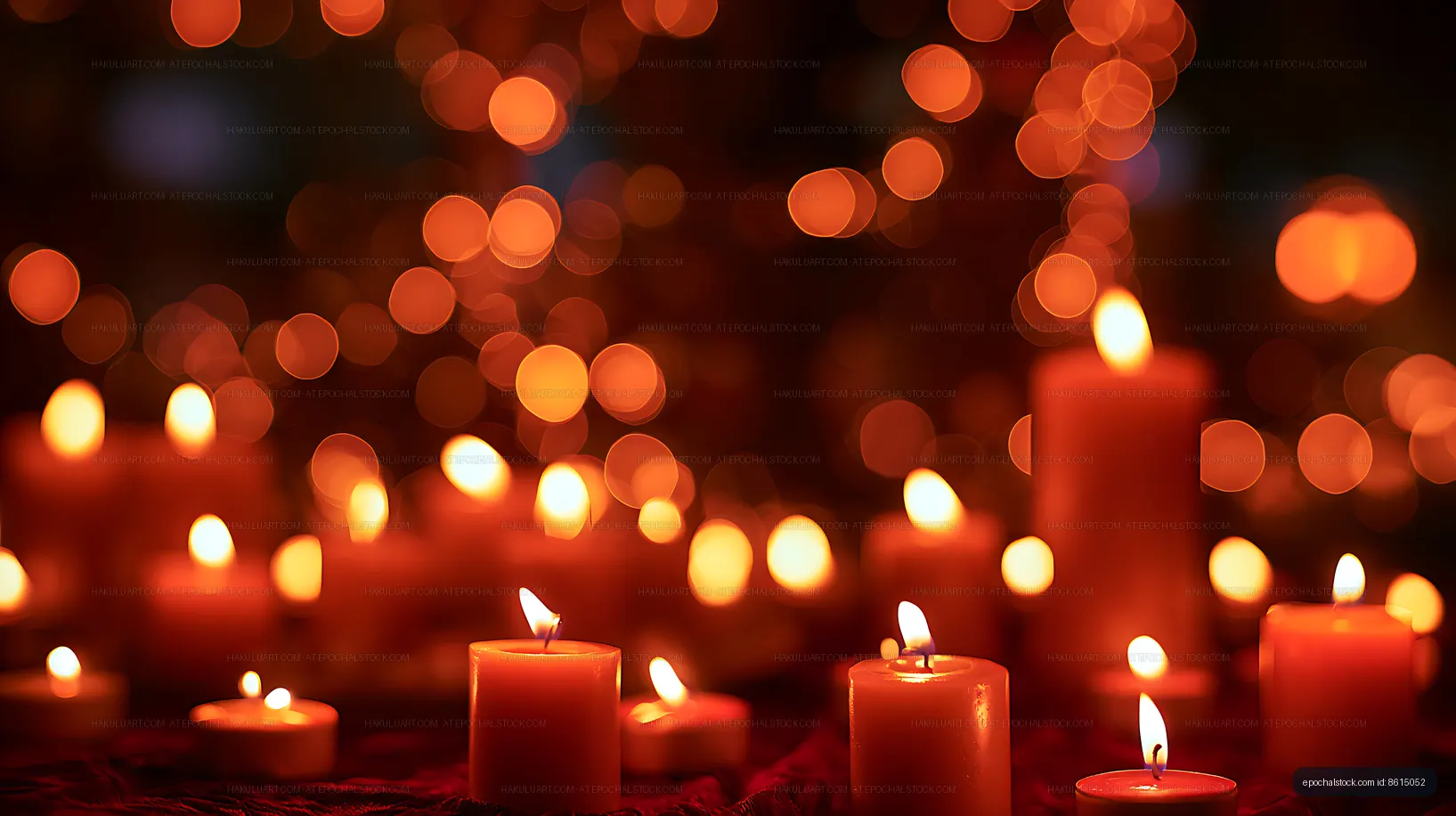 Red candles glowing beneath soft orange bokeh