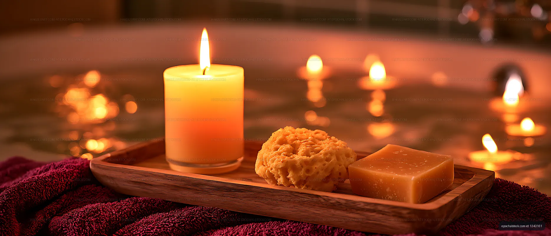 Candlelit bath tray with soap, sponge, and glowing water
