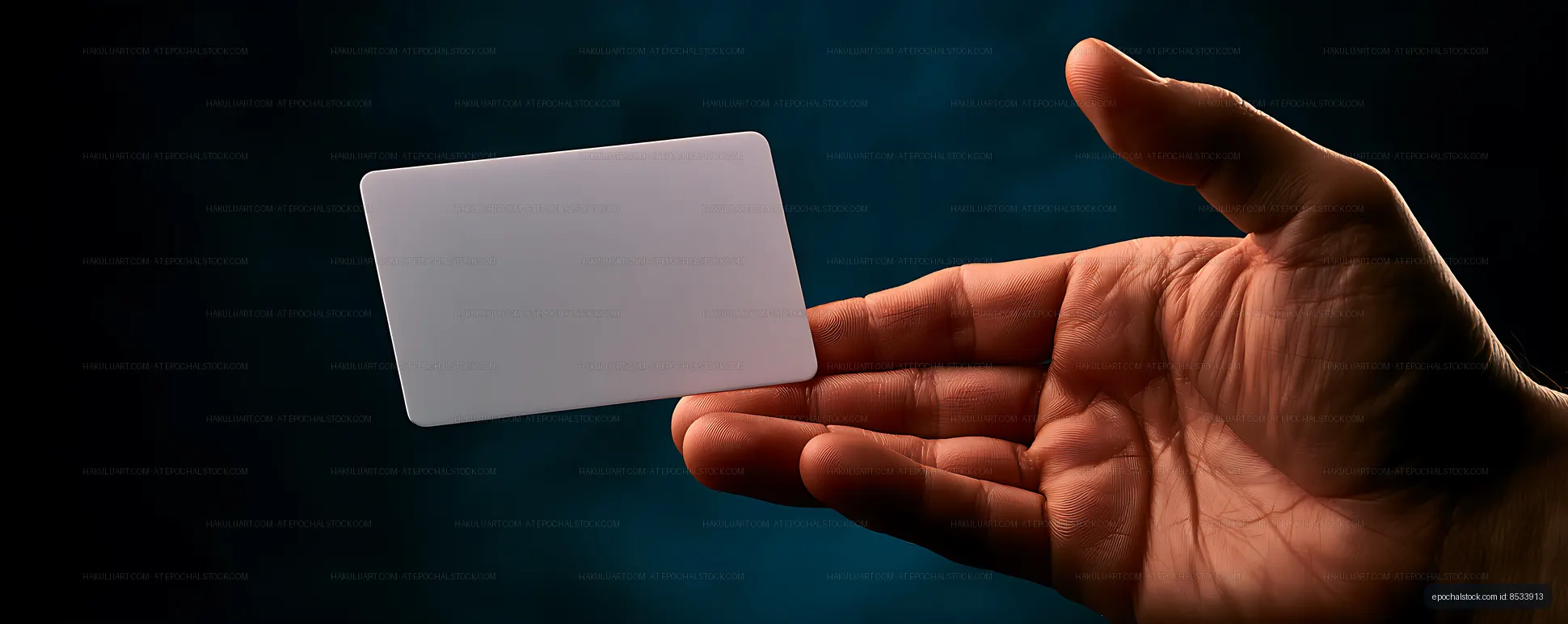 Hand with blank card and copy space on dark background