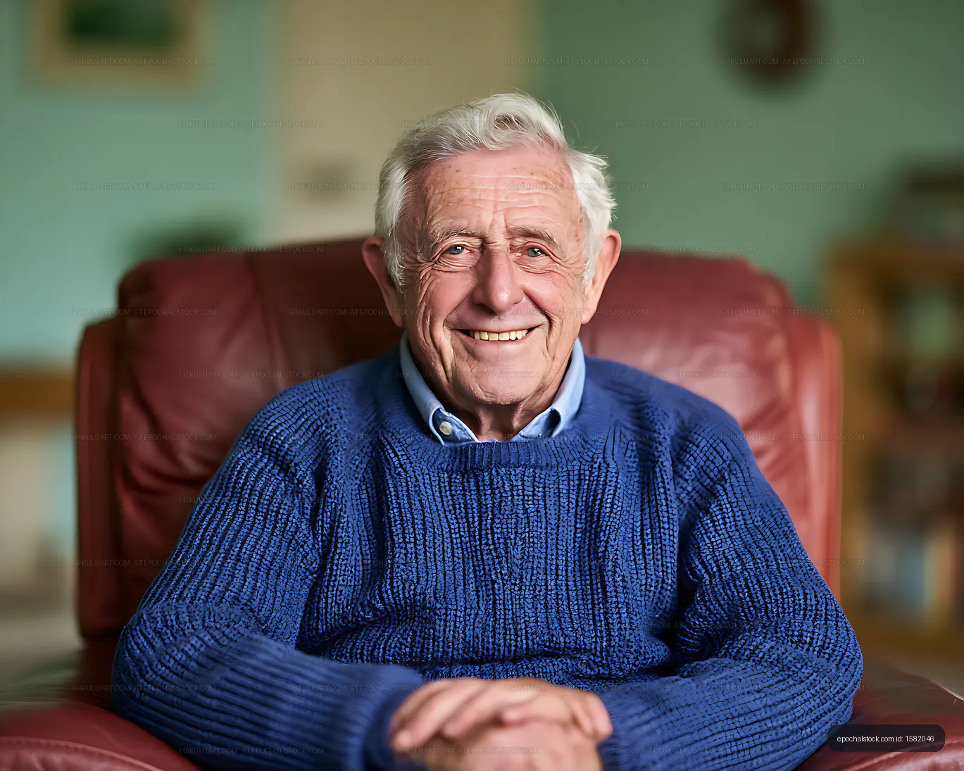 Happy older man relaxing in an armchair at home