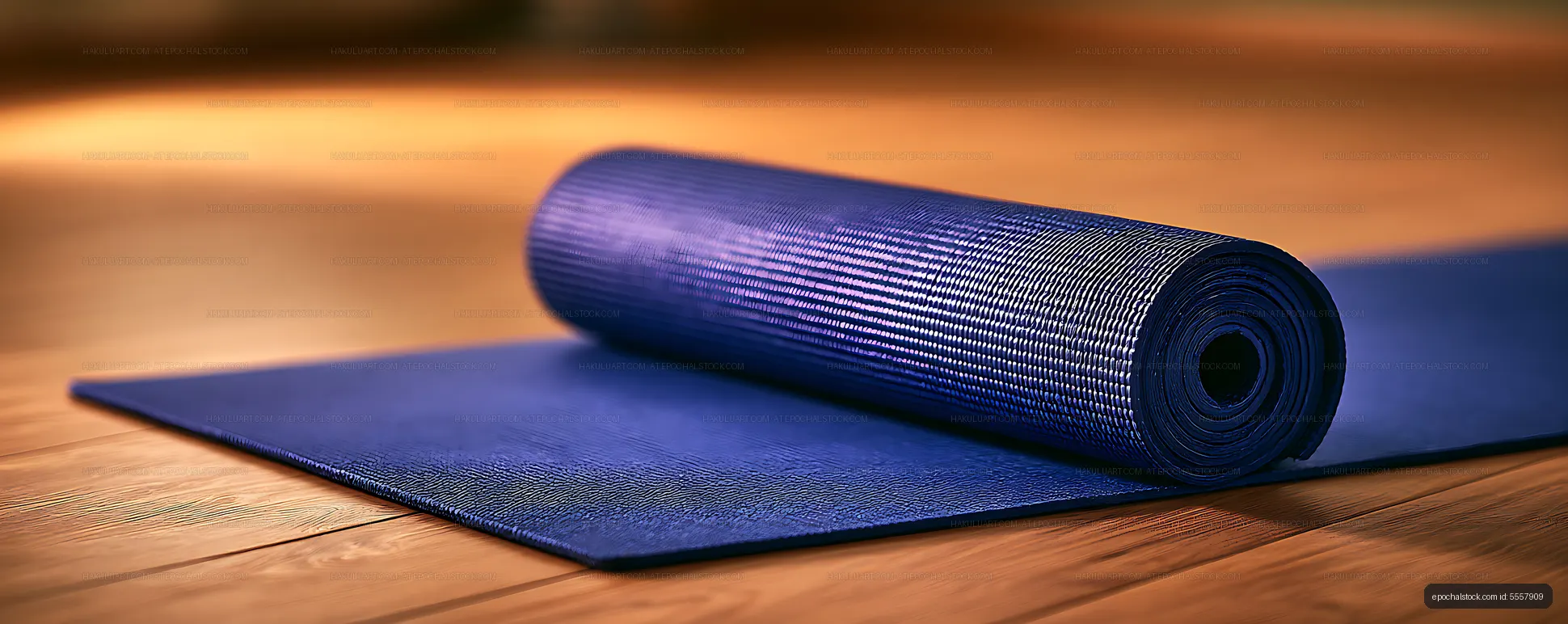 Rolled blue fitness mat on a wooden floor