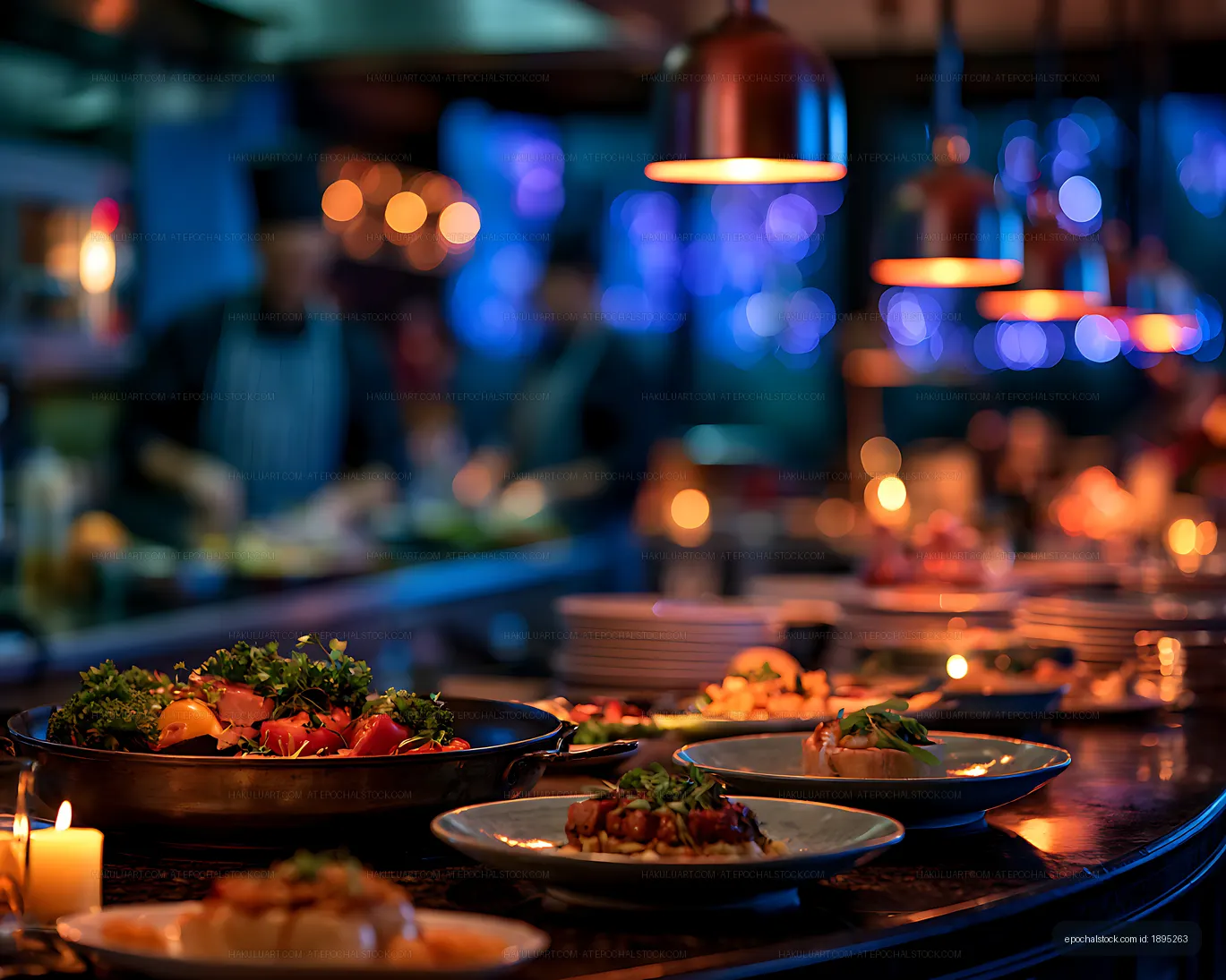 Plated food on an atmospheric candlelit dining table