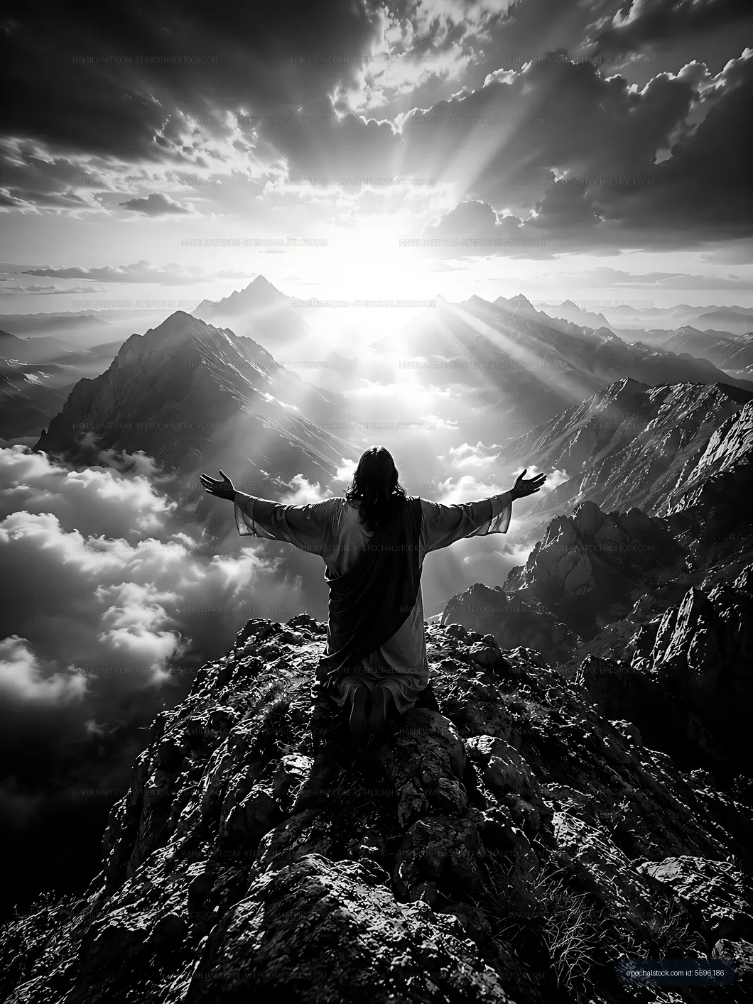 Man with outstretched arms on mountain during sunrise