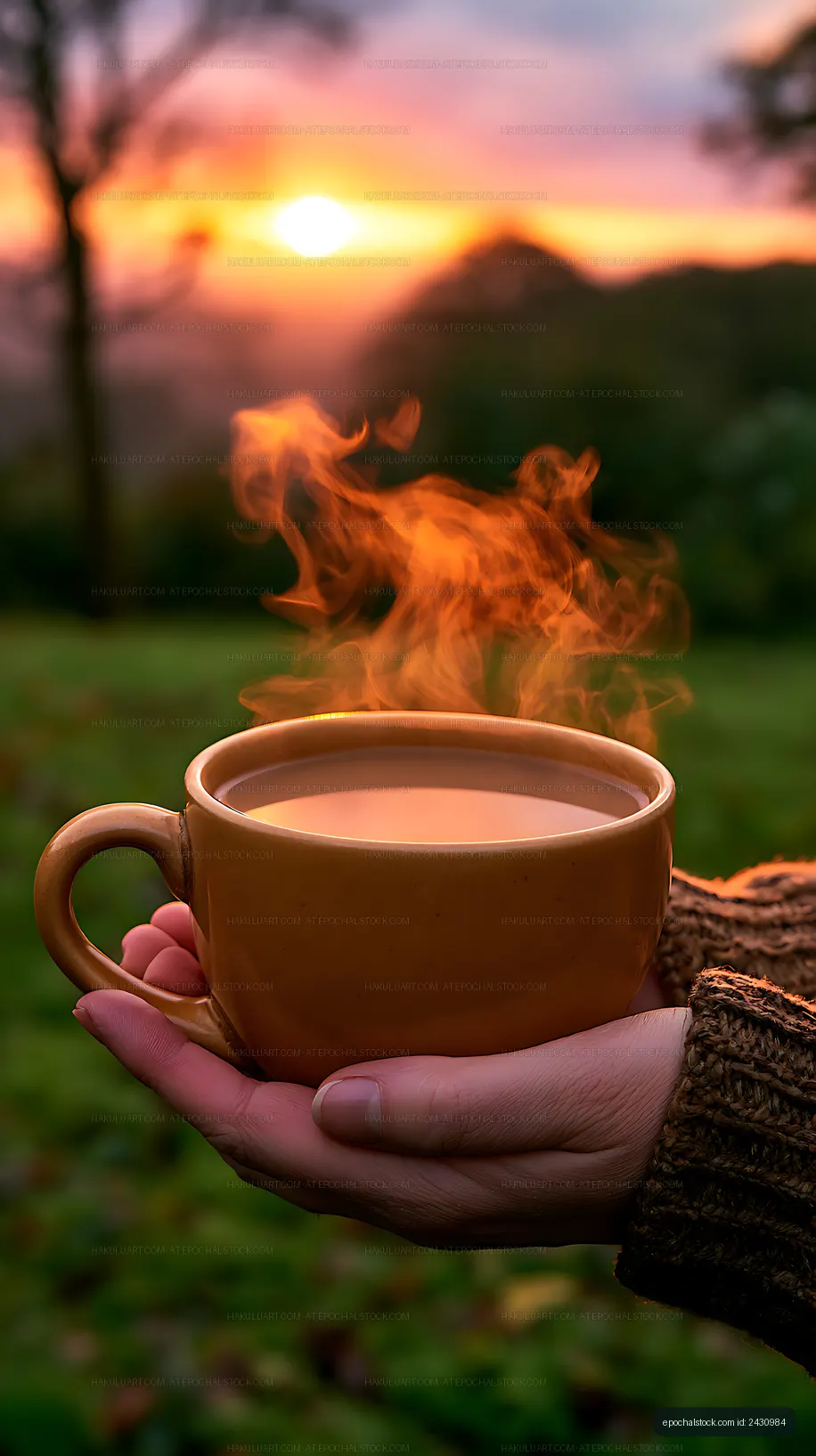 Warm coffee in hand with steam and sunset background