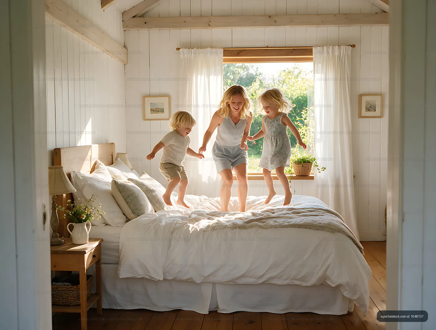 Family jumping together on a bed at home