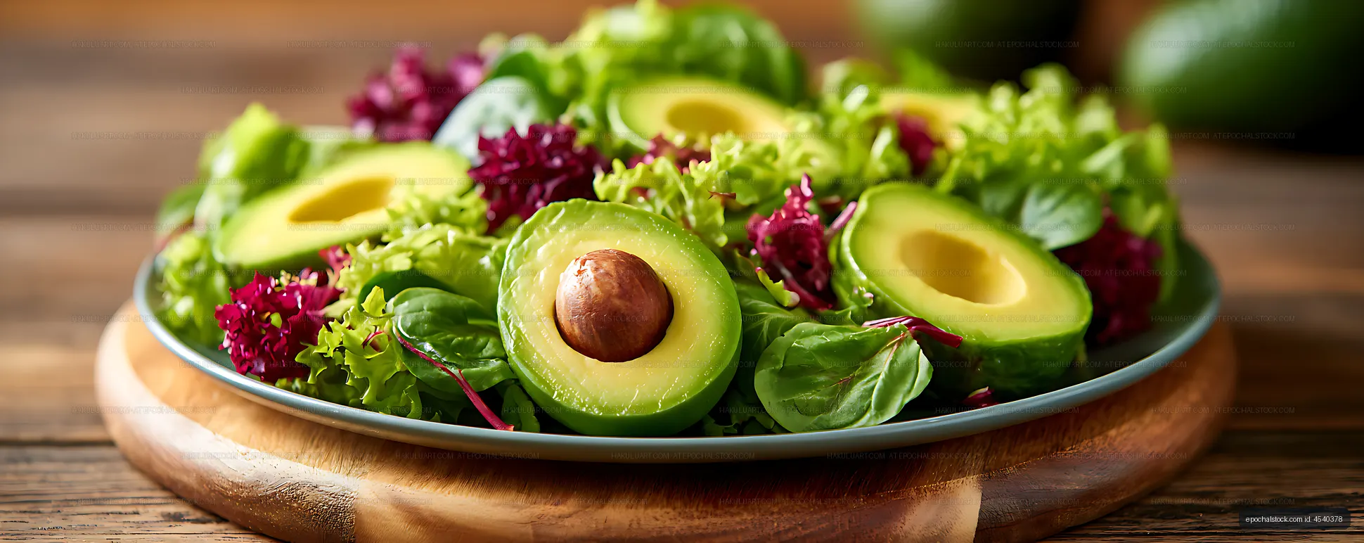 Fresh avocado and leafy green salad served on a plate