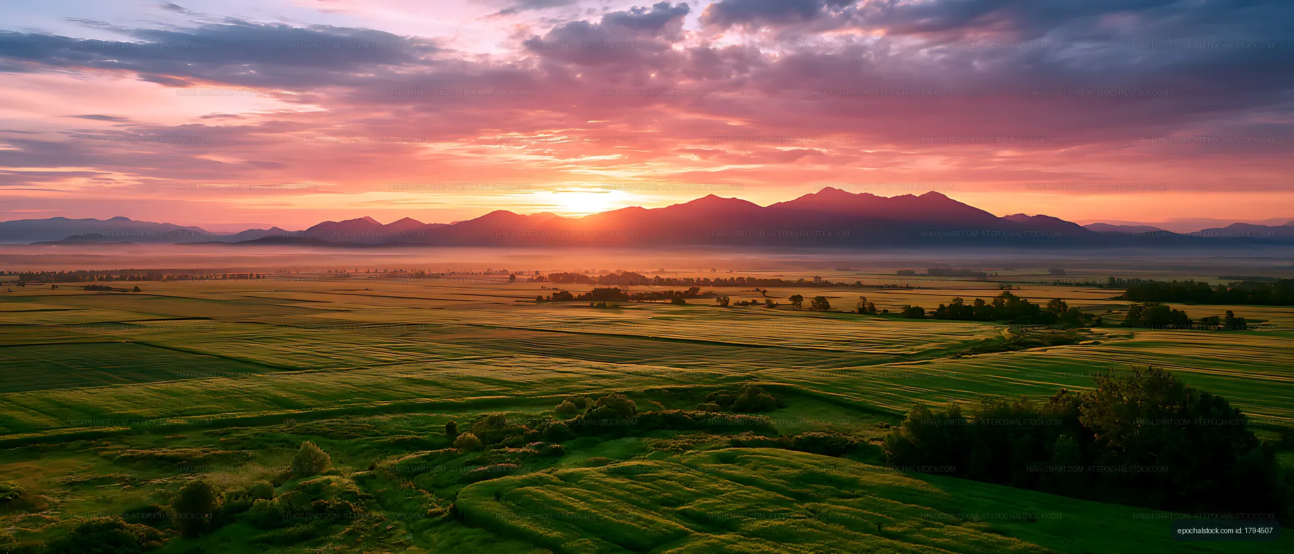 Panoramic sunset landscape with fields and mountains