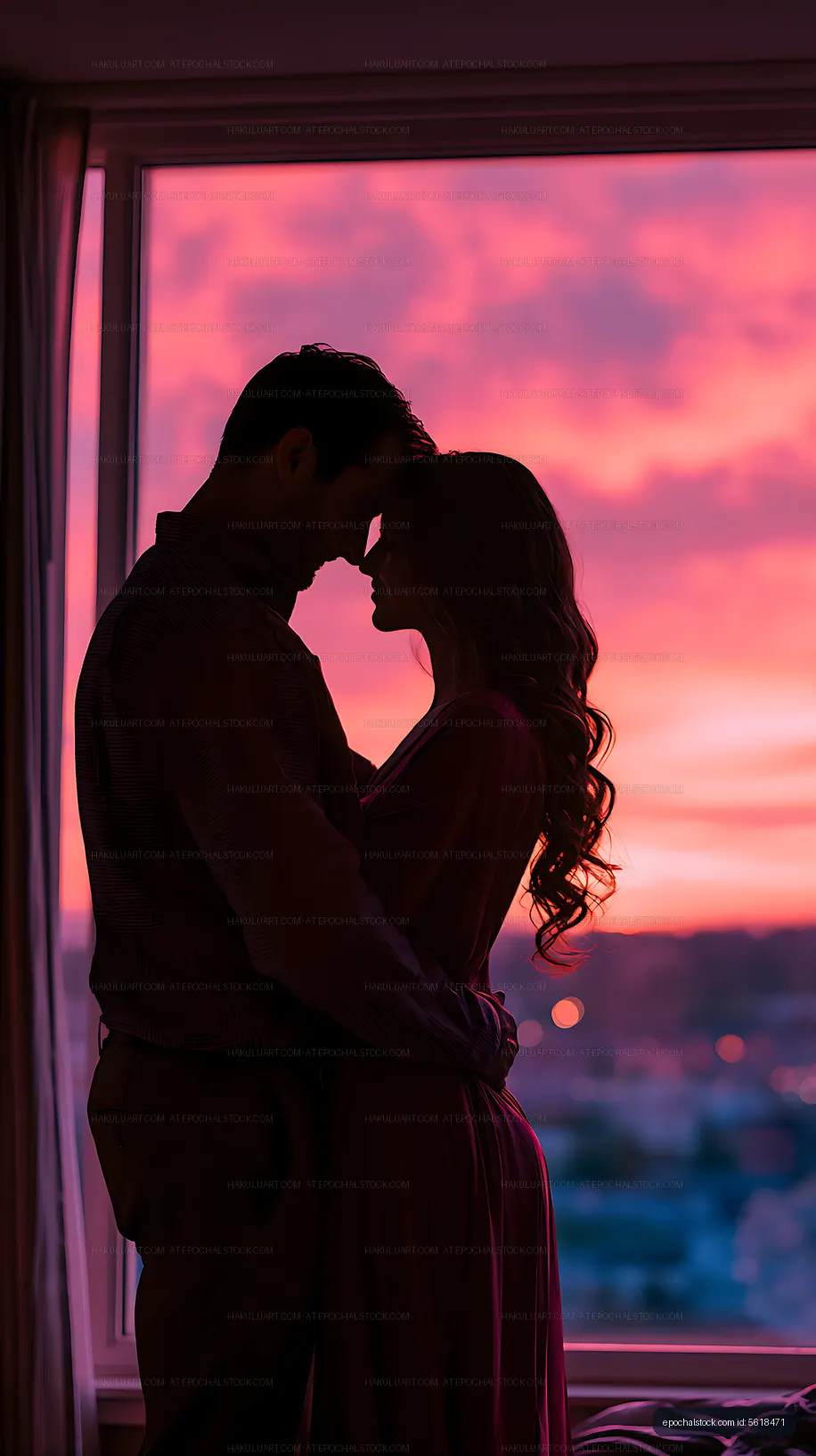 Couple embracing in silhouette against a colorful sunset