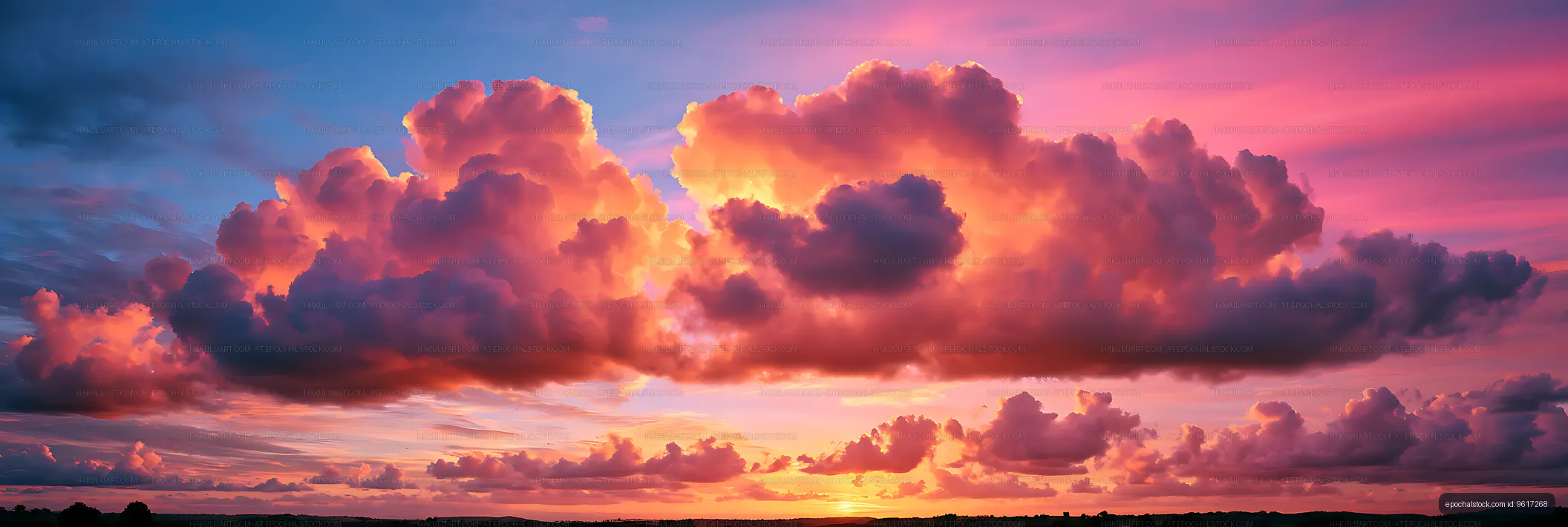Panoramic dramatic sunset sky with glowing clouds