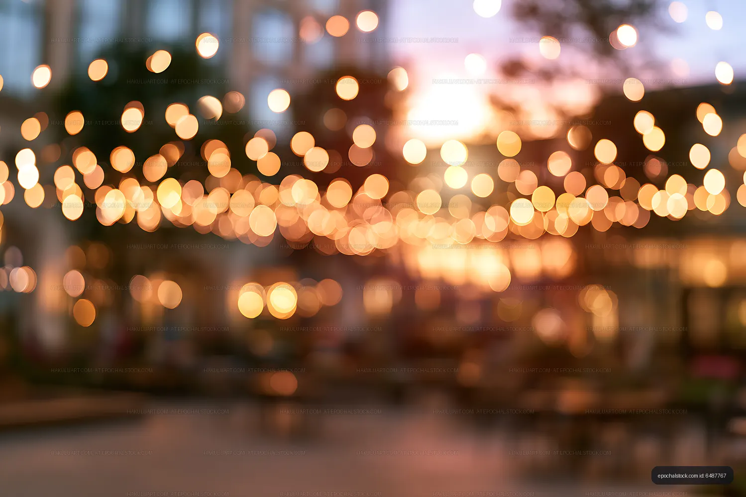 Glowing outdoor string lights with sunset bokeh