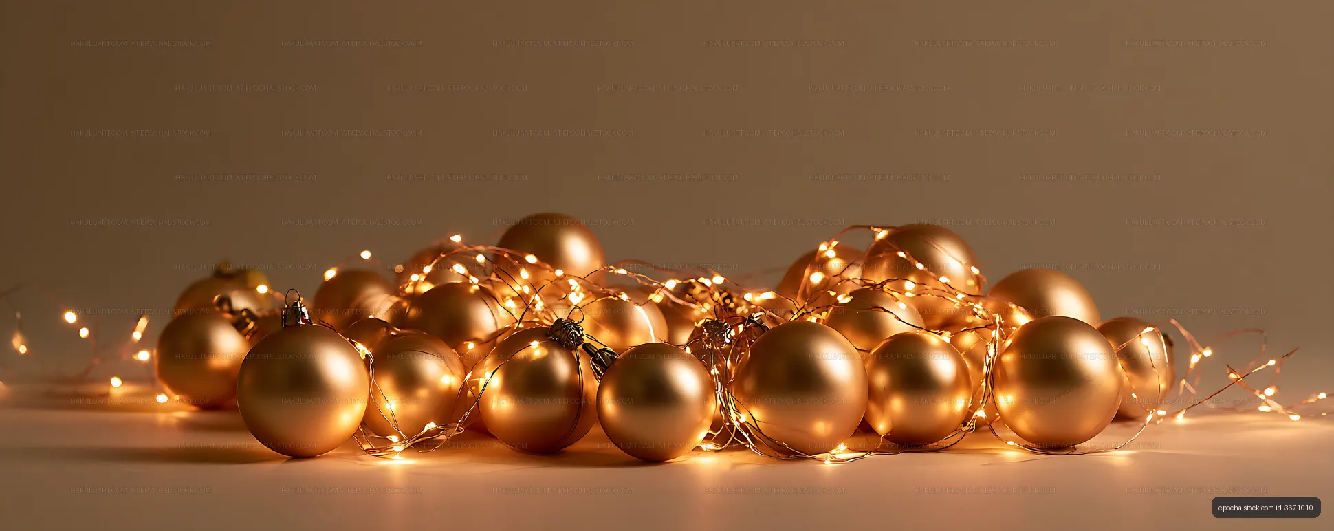 Golden holiday baubles illuminated by string lights