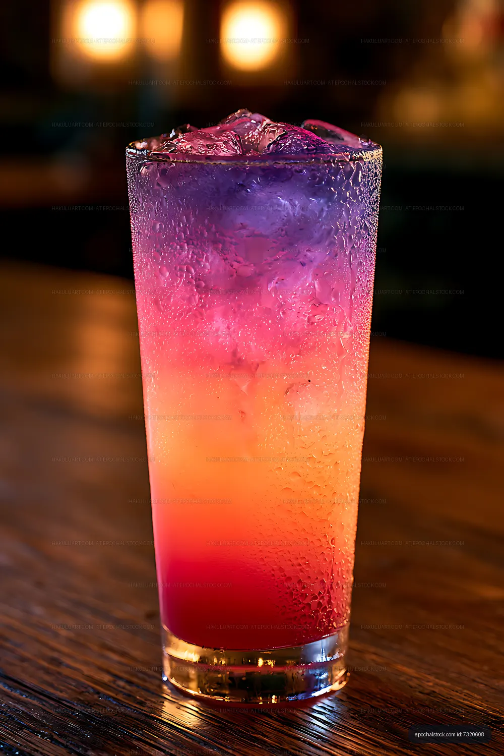 Glowing multicolored drink on a wooden table