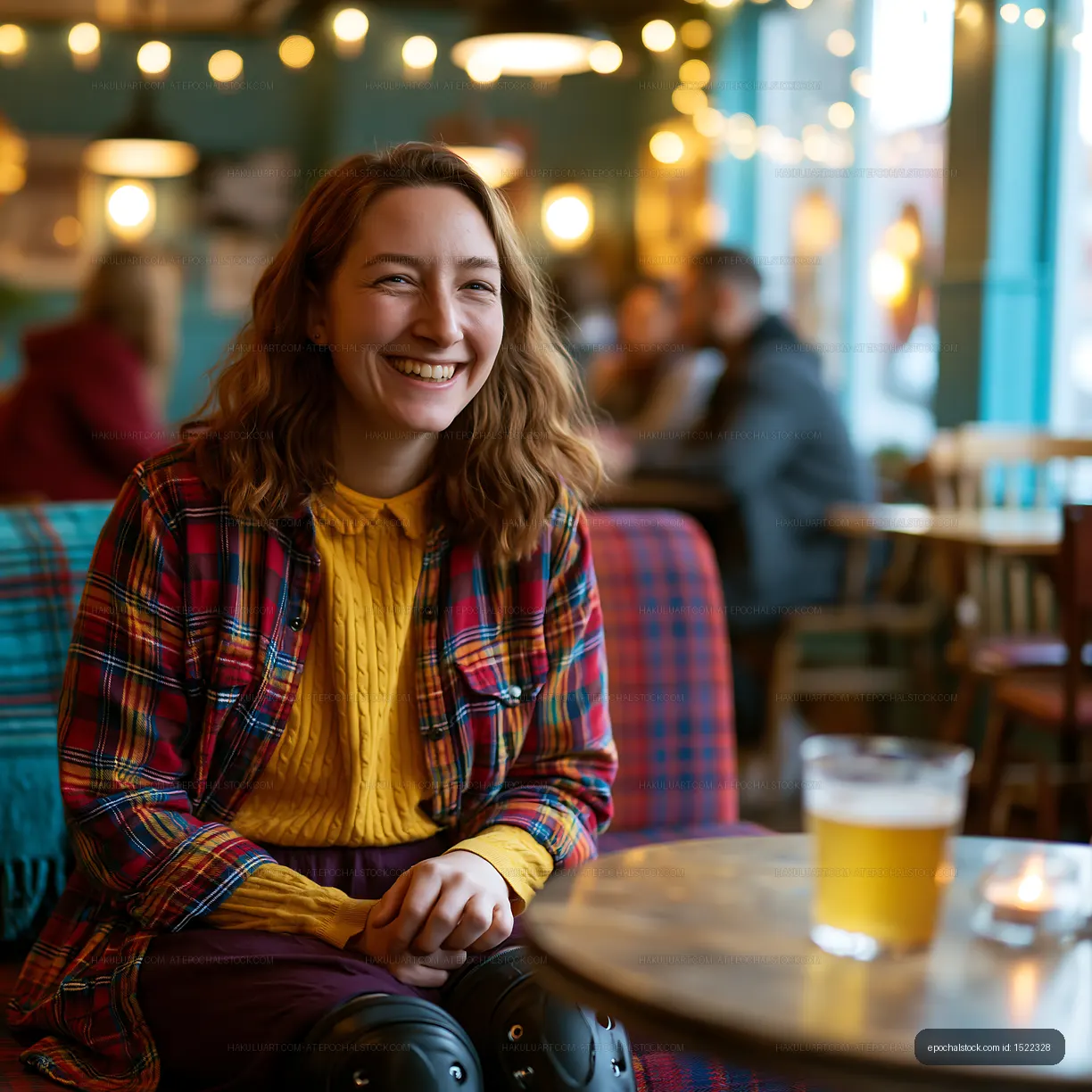 Joyful woman at a pub table with beer
