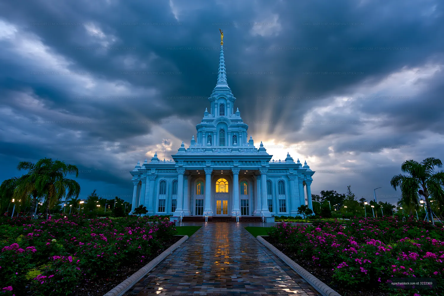 Illuminated ornate temple with reflective path and storm clouds