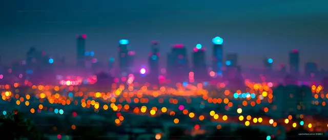 City skyline at night with bright lights and blurred effect