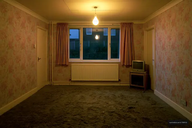 Empty room with vintage decor and a single light bulb