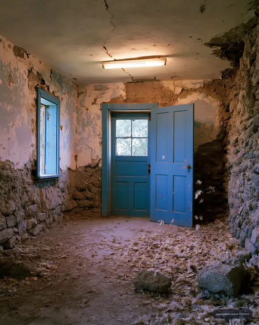Old room with blue doors and cracked walls in abandoned building