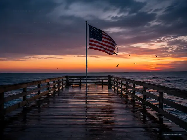 Sunset view from a wooden pier with an American flag