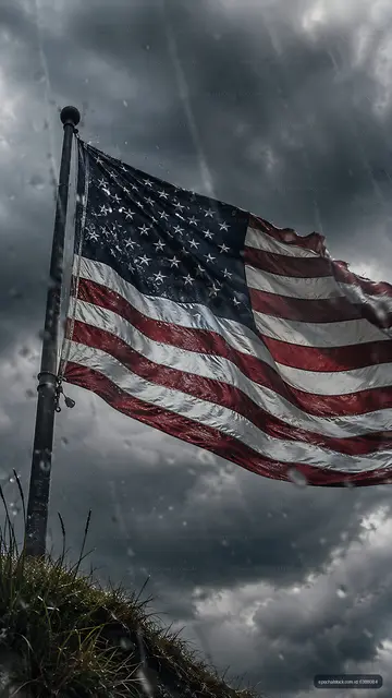 American flag waving against a cloudy sky