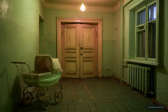 Old hallway with a baby stroller in a vintage apartment