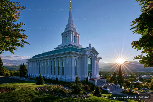 Sunrise over a large church building with a tall steeple
