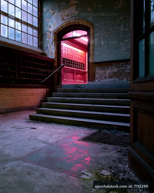 Stairs leading to a pink-lit doorway in an abandoned building