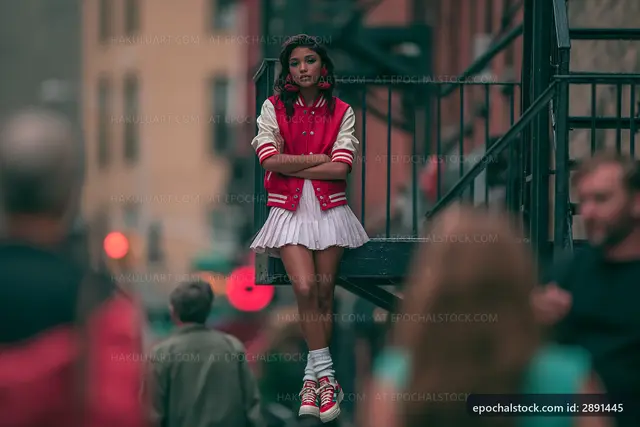 Girl in red jacket stands on stairs in urban setting