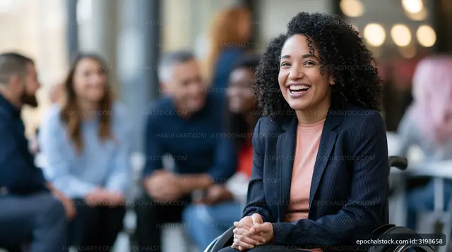 Woman in wheelchair smiles at group during casual meeting