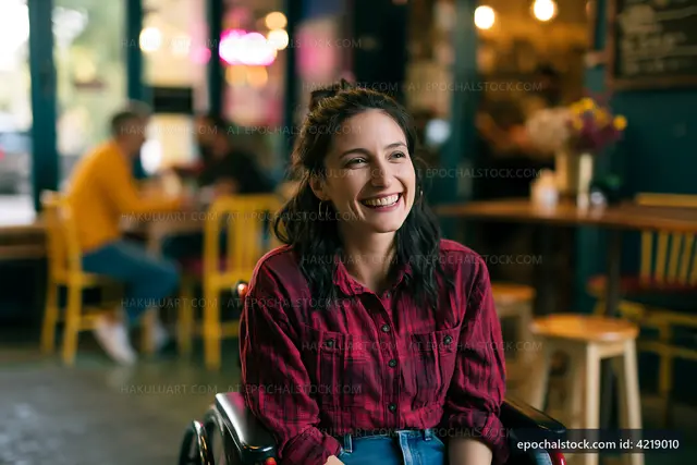 Happy woman in a wheelchair sitting in a cafe