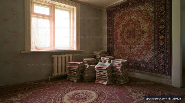 Old room with stacked books and vintage rug