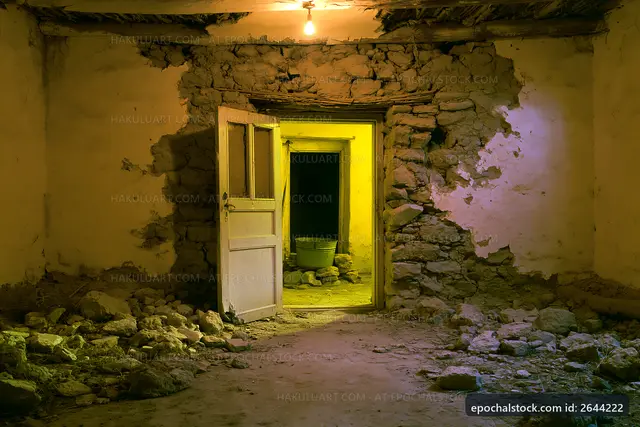 Abandoned room with a door and yellow light from another room