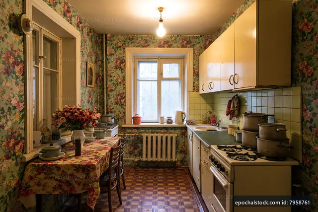 Old-fashioned kitchen with floral wallpaper and cooking items