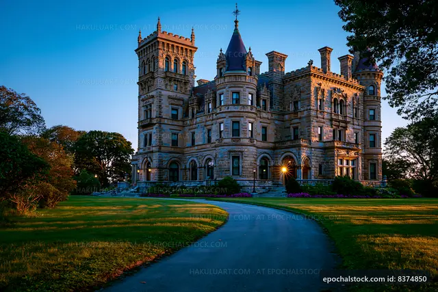 Historic mansion surrounded by lush gardens at sunset