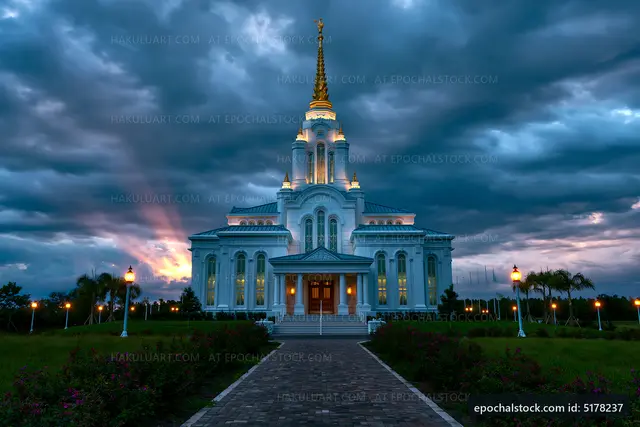 White church building under cloudy sky at sunset