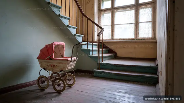 Old baby stroller in an empty staircase area