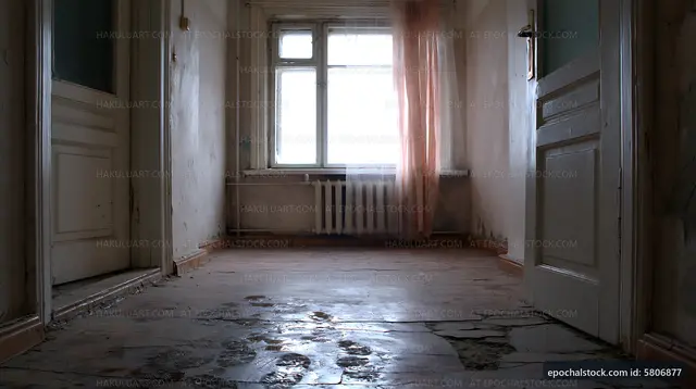 Abandoned hallway with cracked floor and sunlight streaming in