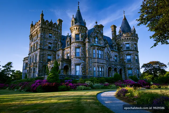 Grand stone castle with manicured gardens in daylight