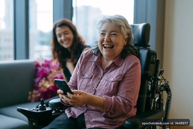 Happy woman in wheelchair using smartphone with friend