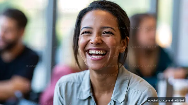 Woman smiling while sitting in a cafe with friends
