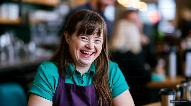Friendly barista serving coffee in a busy cafe