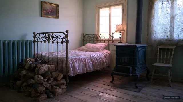 Cozy bedroom with a vintage bed and wood stove