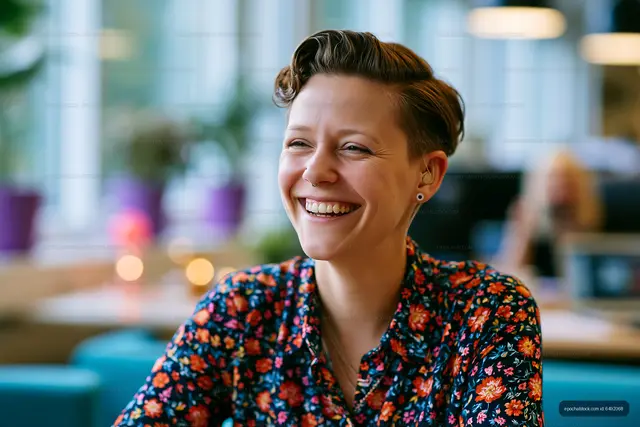 Woman smiling in a cafe with bright decor and natural light
