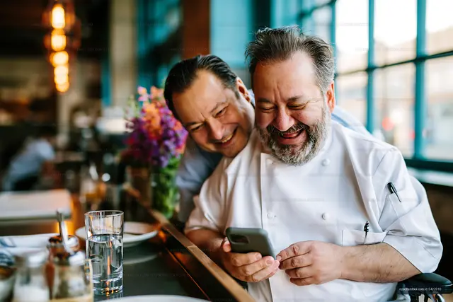 Chefs smiling and sharing a moment in a restaurant