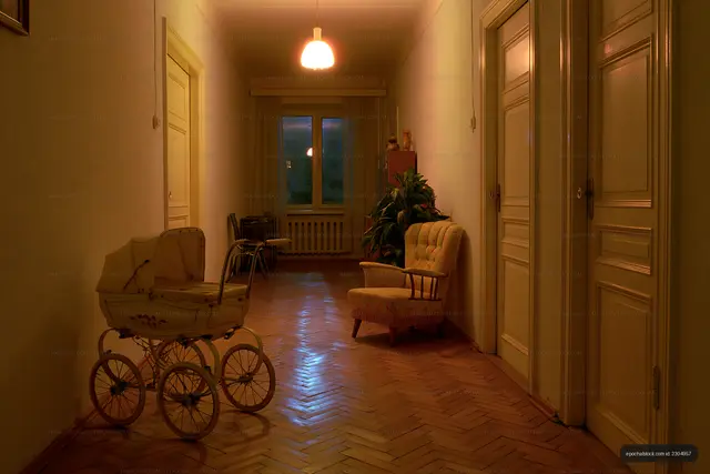Vintage hallway with a stroller and an armchair at night